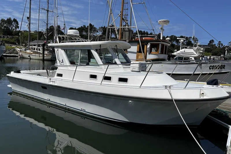 Slide: The Image of 2005 Albin 28 Tournament Express boat docked in a marina under clear blue skies. - 1