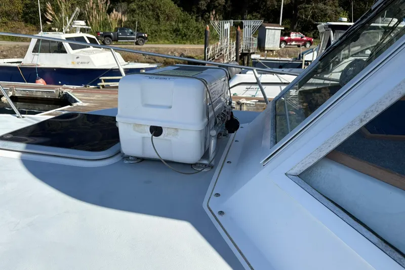 Slide: The Image of 2005 Albin 28 Tournament Express boat with equipment on deck, docked near other vessels. - 10