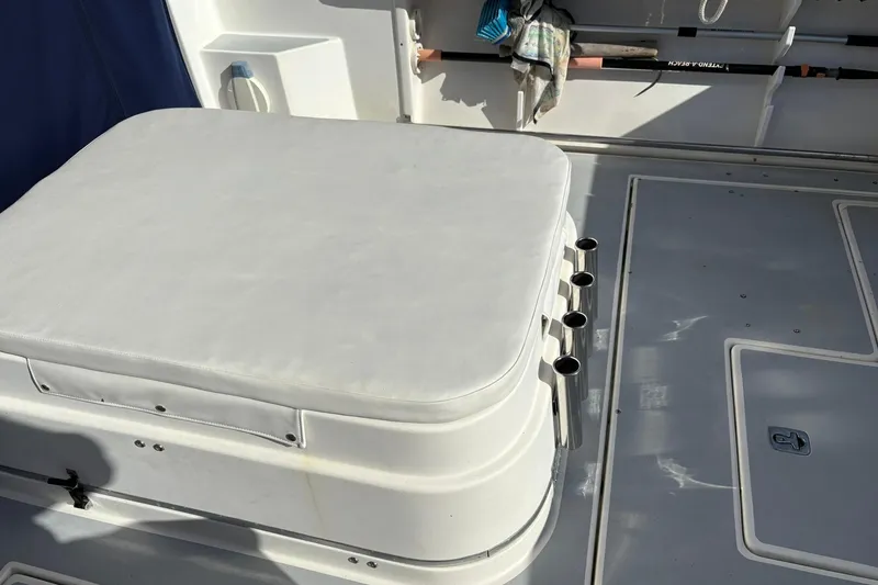 Slide: The Image of 2005 Albin 28 Tournament Express boat interior with cushioned seating and rod holders. - 11