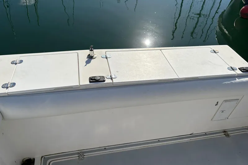 Slide: The Image of 2005 Albin 28 Tournament Express boat deck with storage compartments and water reflection. - 12