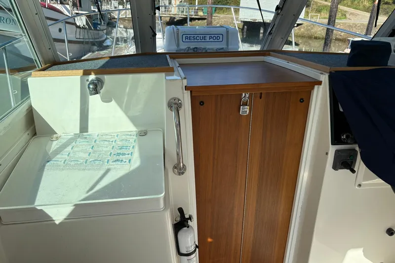 Slide: The Image of Interior of 2005 Albin 28 Tournament Express boat with wooden cabinetry and sink. - 19