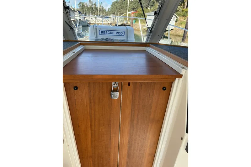 Slide: The Image of 2005 Albin 28 Tournament Express cabin door with lock, featuring a wooden finish. - 22