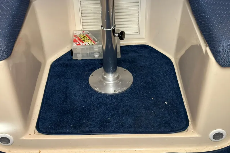 Slide: The Image of 2005 Albin 28 Tournament Express interior with blue carpet and storage box. - 28