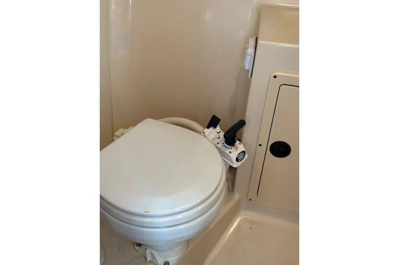Slide: The Image of 2005 Albin 28 Tournament Express marine toilet with manual flush controls. - 30