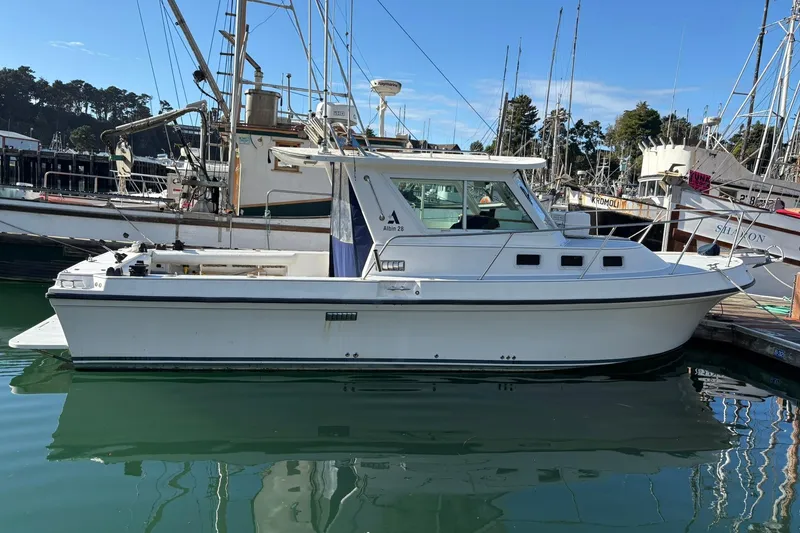 Slide: The Image of 2005 Albin 28 Tournament Express boat docked in a marina, side view. - 4