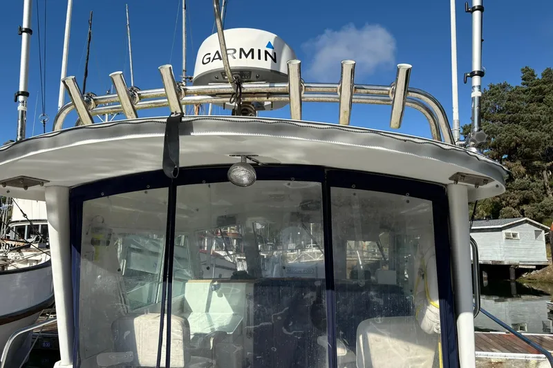 Slide: The Image of 2005 Albin 28 Tournament Express boat with Garmin radar, docked under clear blue sky. - 7