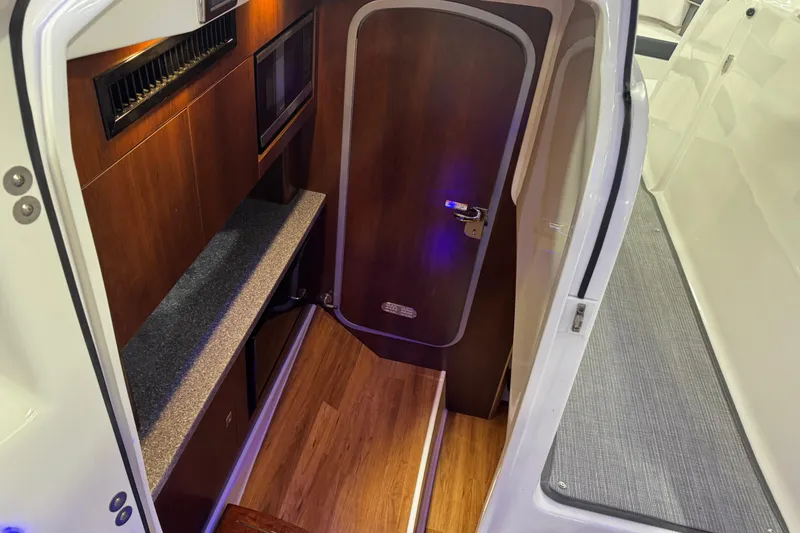 Slide: The Image of 2019 Chaparral 347 SSX cabin interior with wood finish and modern amenities. - 17