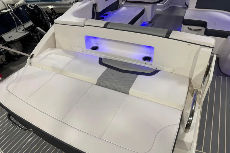 Slide: The Image of 2019 Chaparral 347 SSX boat interior with cushioned seating and blue LED lighting. - 21