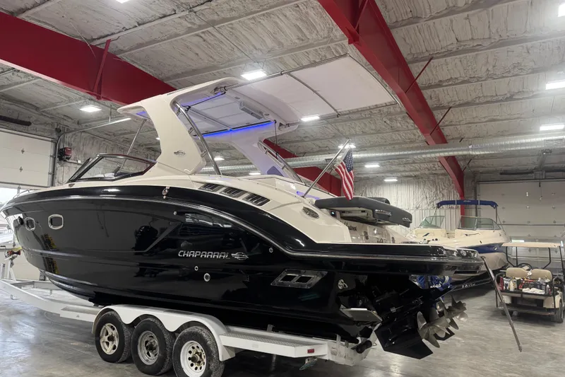 Slide: The Image of 2019 Chaparral 347 SSX boat in a warehouse, on a trailer, with American flag. - 3