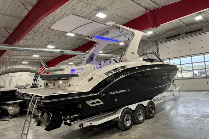 Slide: The Image of 2019 Chaparral 347 SSX boat in a showroom on a trailer. - 4