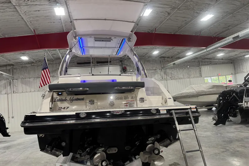 Slide: The Image of 2019 Chaparral 347 SSX boat in a showroom, featuring sleek design and American flag. - 5