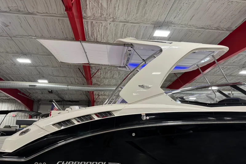 Slide: The Image of 2019 Chaparral 347 SSX boat with sleek design in indoor showroom. - 6