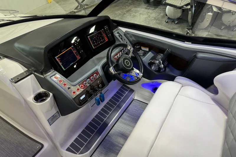 Slide: The Image of 2019 Chaparral 347 SSX boat cockpit with modern controls and leather seating. - 9