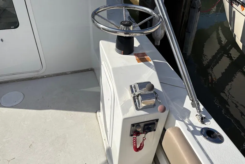 Slide: The Image of 2019 Parker 2320 Sport Cabin boat steering console and controls. - 4