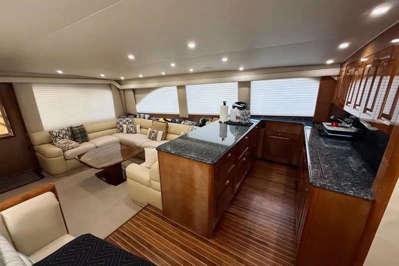 Slide: The Image of Luxurious interior of a 2004 Viking 65 Convertible yacht with elegant seating and modern kitchen. - 19