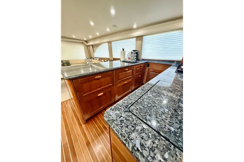 Slide: The Image of Luxurious interior of 2004 Viking 65 Convertible yacht with granite countertops and wooden flooring. - 22