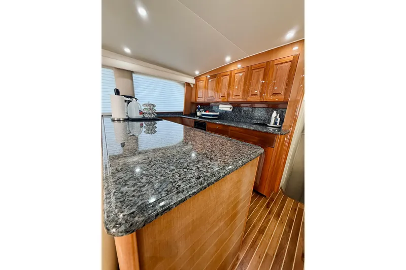Slide: The Image of Luxurious kitchen interior of 2004 Viking 65 Convertible yacht with granite countertops. - 24