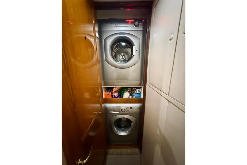 Slide: The Image of Laundry area inside 2004 Viking 65 Convertible yacht with stacked washer and dryer. - 25