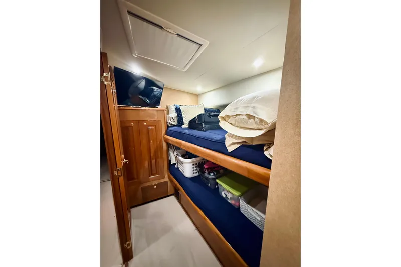 Slide: The Image of Interior of 2004 Viking 65 Convertible yacht with bunk beds and storage. - 28
