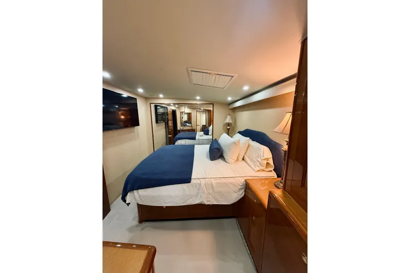 Slide: The Image of Luxurious bedroom interior of 2004 Viking 65 Convertible yacht with elegant furnishings. - 30