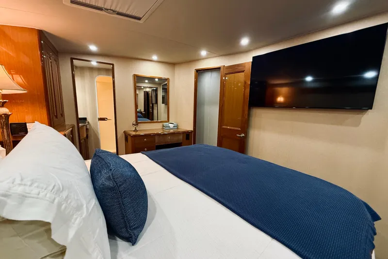 Slide: The Image of Luxurious bedroom interior of 2004 Viking 65 Convertible yacht with modern amenities. - 32