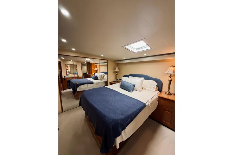 Slide: The Image of Luxurious bedroom interior of 2004 Viking 65 Convertible yacht with elegant decor. - 34