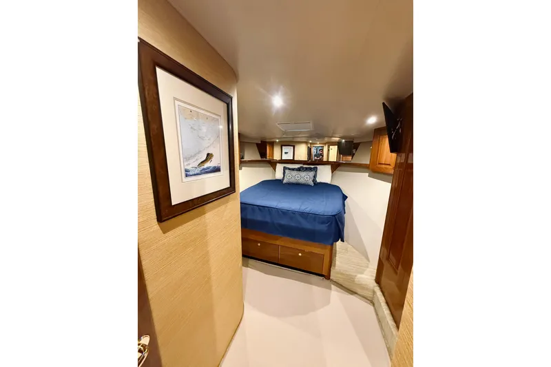 Slide: The Image of Luxurious cabin interior of 2004 Viking 65 Convertible yacht with cozy bed and elegant decor. - 35