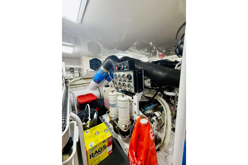 Slide: The Image of Engine room of 2004 Viking 65 Convertible yacht with control panel and maintenance supplies. - 40