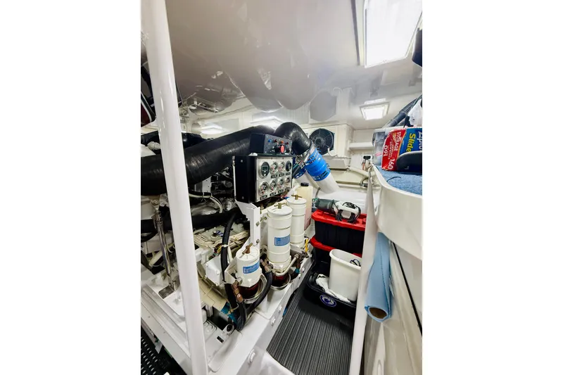 Slide: The Image of Engine room of 2004 Viking 65 Convertible yacht, showcasing mechanical components and storage. - 41