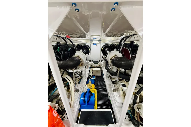 Slide: The Image of Engine room of a 2004 Viking 65 Convertible yacht, showcasing dual engines and mechanical components. - 42