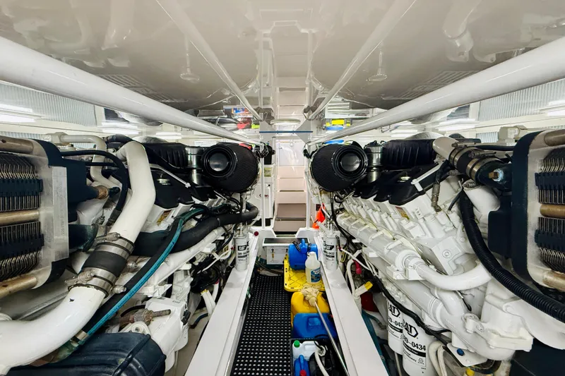 Slide: The Image of Engine room of a 2004 Viking 65 Convertible yacht, showcasing dual engines and mechanical components. - 51