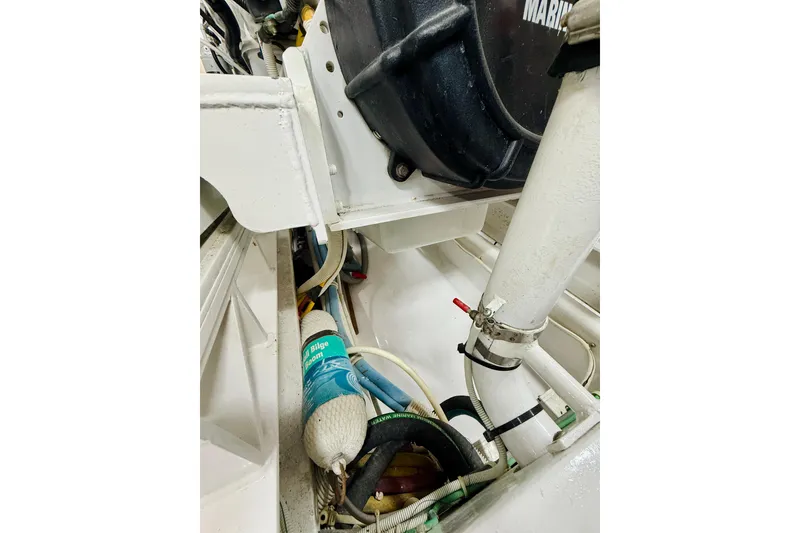Slide: The Image of Engine room of 2004 Viking 65 Convertible yacht, showcasing mechanical components and bilge area. - 54