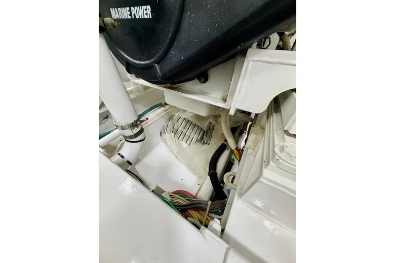 Slide: The Image of Engine compartment of 2004 Viking 65 Convertible boat, featuring Marine Power components. - 55