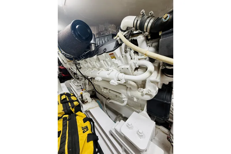 Slide: The Image of Engine room of a 2004 Viking 65 Convertible yacht, showcasing a powerful marine engine. - 59