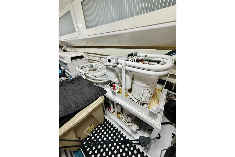 Slide: The Image of Engine room of 2004 Viking 65 Convertible yacht, showcasing mechanical components and storage. - 60