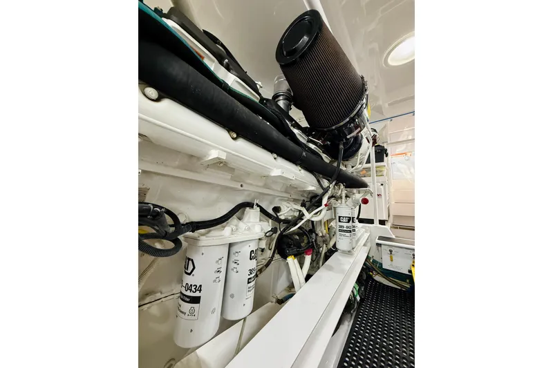 Slide: The Image of Engine room of a 2004 Viking 65 Convertible yacht, showcasing filters and components. - 61