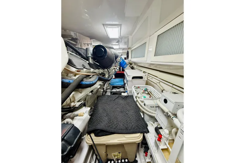 Slide: The Image of Engine room of a 2004 Viking 65 Convertible yacht, showcasing mechanical components and equipment. - 62