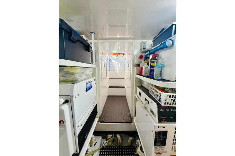 Slide: The Image of Engine room of 2004 Viking 65 Convertible yacht, featuring organized storage and equipment. - 64