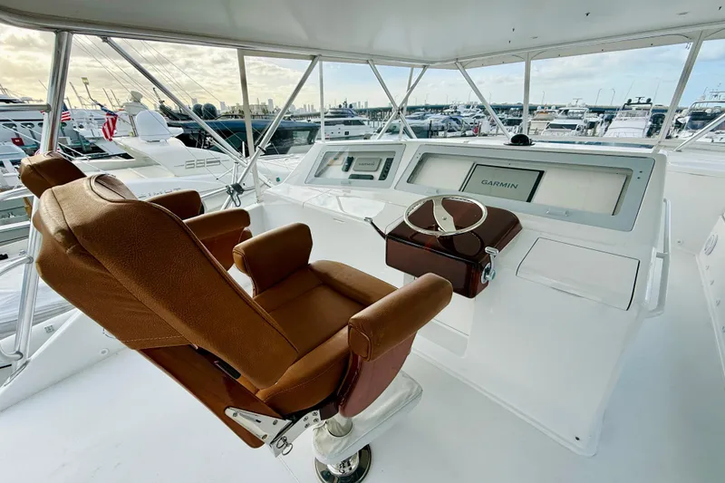 Slide: The Image of Luxurious helm of 2004 Viking 65 Convertible yacht with leather captain's chair and navigation equipment. - 72