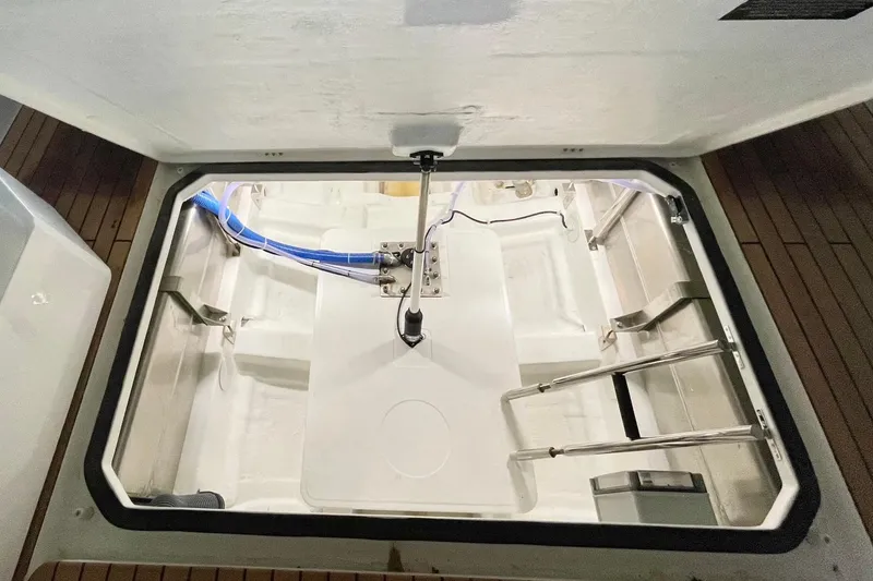 Slide: The Image of Open refrigerator and storage compartments on Schaefer V33 yacht, 2026 model, with wooden flooring. - 18