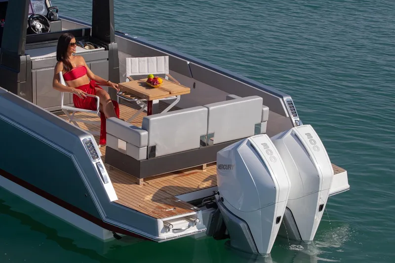 Slide: The Image of 2026 Schaefer V34 boat cruising on open water, rear view. - 2