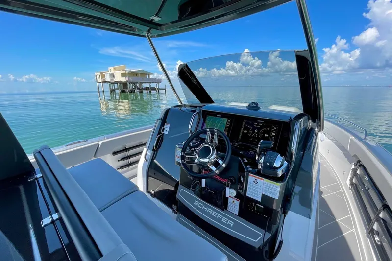 Slide: The Image of Luxurious 2026 Schaefer V33 yacht interior with sleek kitchen and modern steering console. - 7
