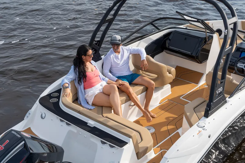 Slide: The Image of Couple relaxing on 2026 Bayliner V20 boat, enjoying a sunny day on the water. - 10