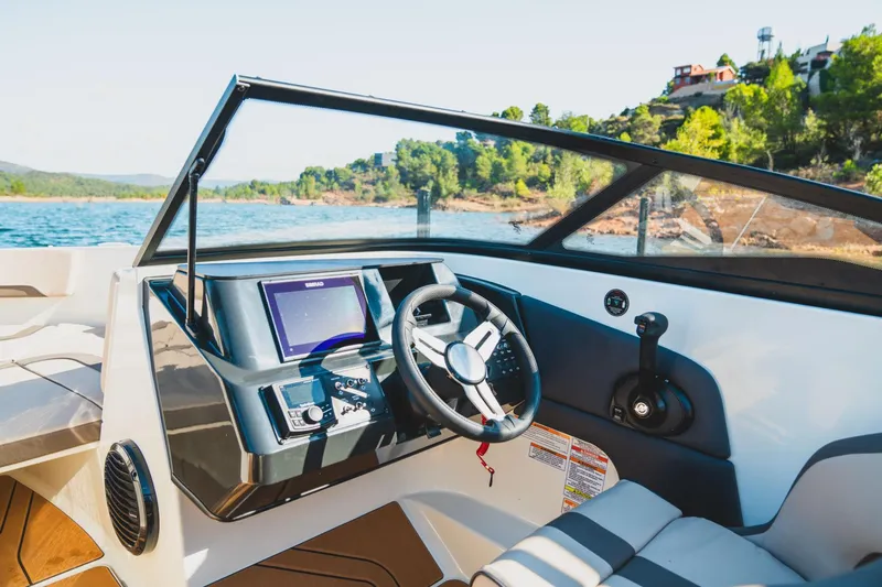Slide: The Image of Manufacturer Provided Image: 2025 Bayliner V20 boat cockpit with modern controls and scenic lake view. - 5
