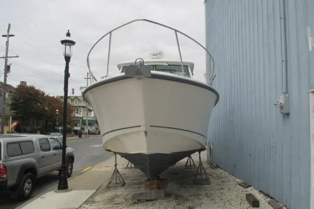 Slide: The Image of 2013 Boston Whaler 315 Conquest boat deck with windshield and railing. - 10
