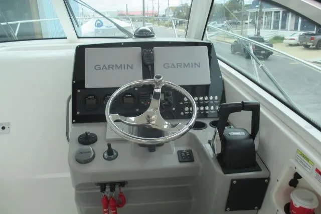 Slide: The Image of 2013 Boston Whaler 315 Conquest boat deck view at a dockside location. - 12