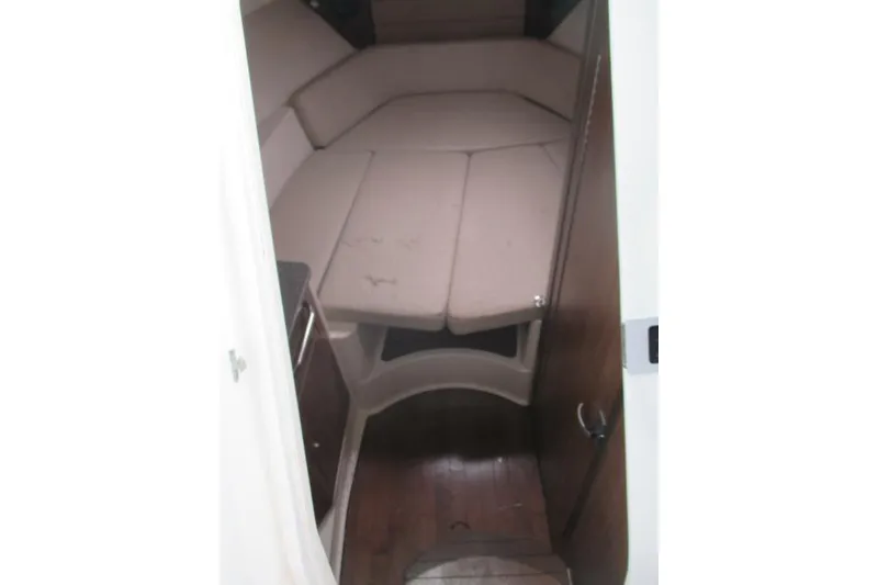 Slide: The Image of 2013 Boston Whaler 315 Conquest boat cockpit with protective cover and rod holders. - 13