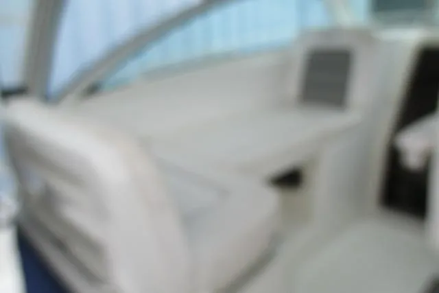 Slide: The Image of 2013 Boston Whaler 315 Conquest boat interior with foldable seating and Yamaha engine. - 15