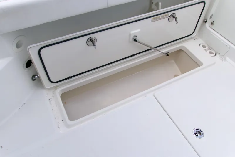 Slide: The Image of 2013 Boston Whaler 315 Conquest storage compartment, open and empty. - 21