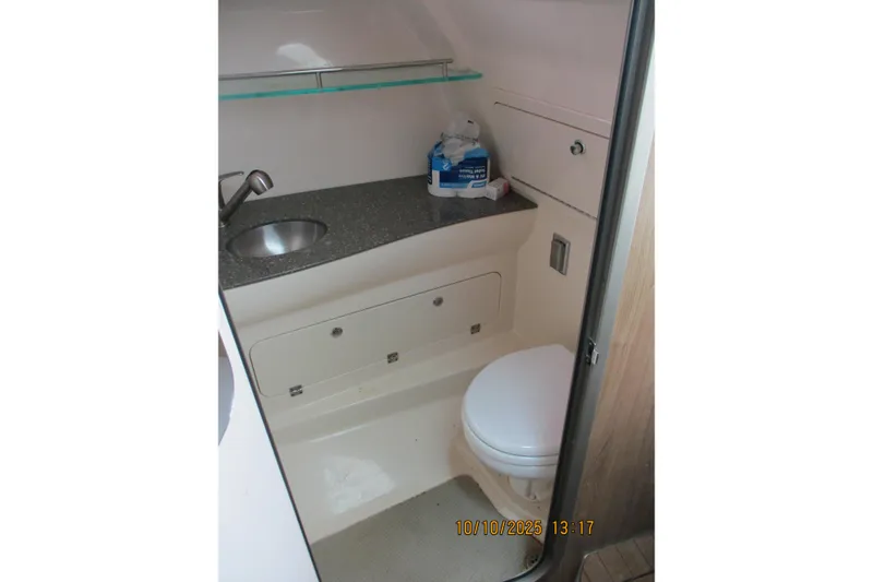 Slide: The Image of 2013 Boston Whaler 315 Conquest bathroom with sink and toilet. - 22